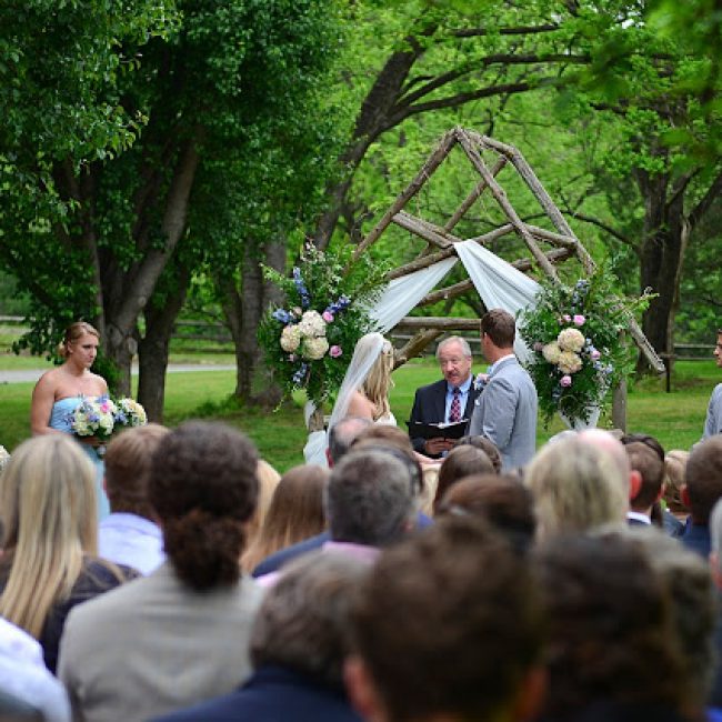 wedding ceremony in apple orchard featuring couple at the altar